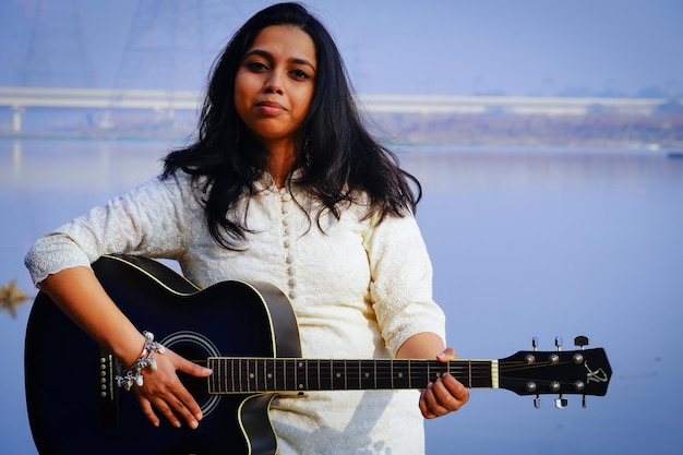 Young woman playing acoustic guitar