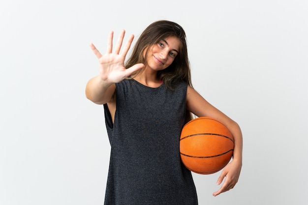 Young woman playing basketball isolated on counting five with fingers