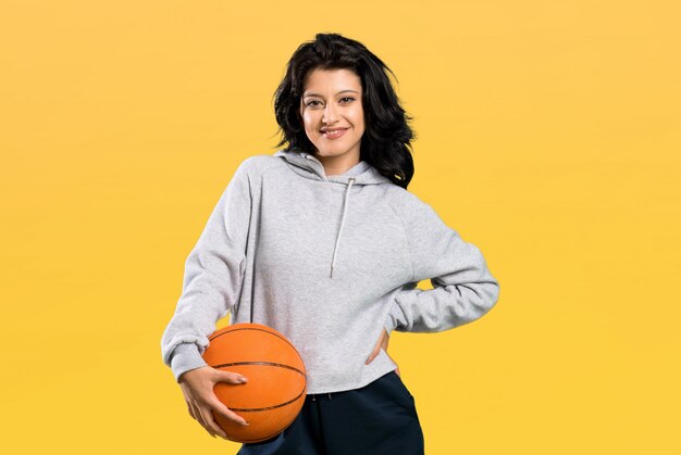 Young woman playing basketball