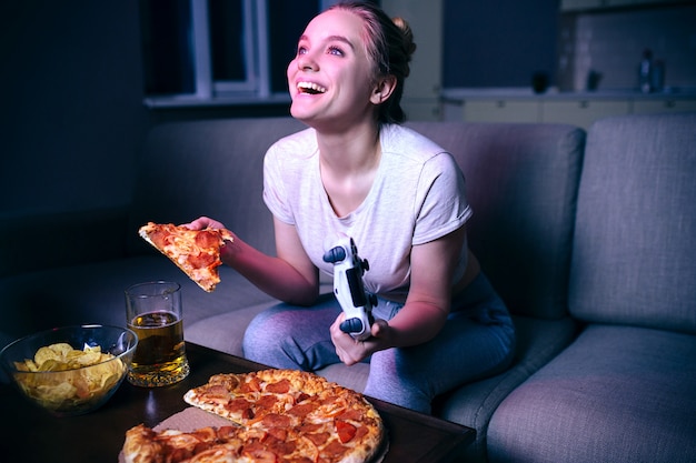 Young woman playing game at night.