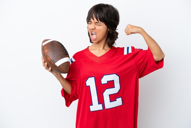 Young woman playing rugby isolated on white background doing strong gesture