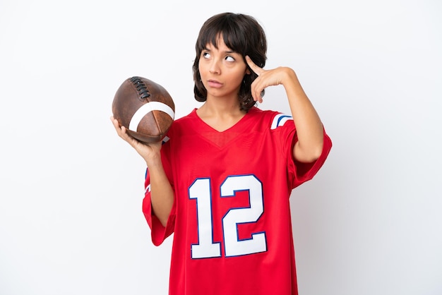 Photo young woman playing rugby isolated on white background having doubts and thinking