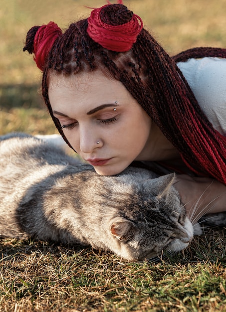 Young woman playing with cat