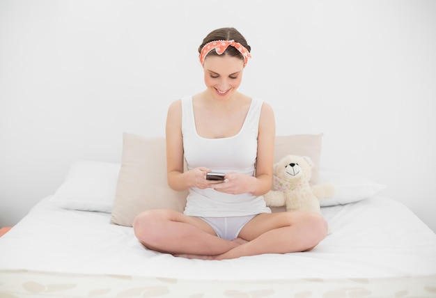 Young woman playing with her smartphone