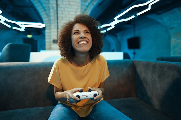 A young woman plays on a console