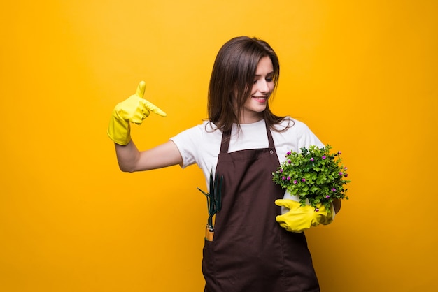 Young woman pointed on a plant isolated