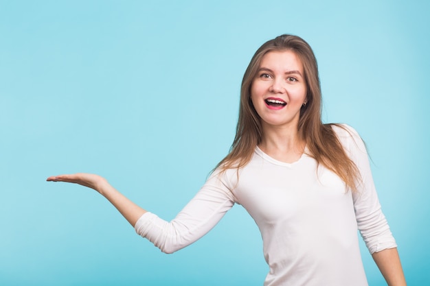 Young woman pointing at copy space  