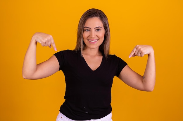 Young woman pointing down On here