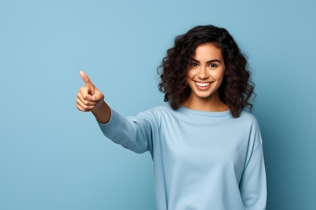 Young woman pointing finger to side adult girl isolated on blue background