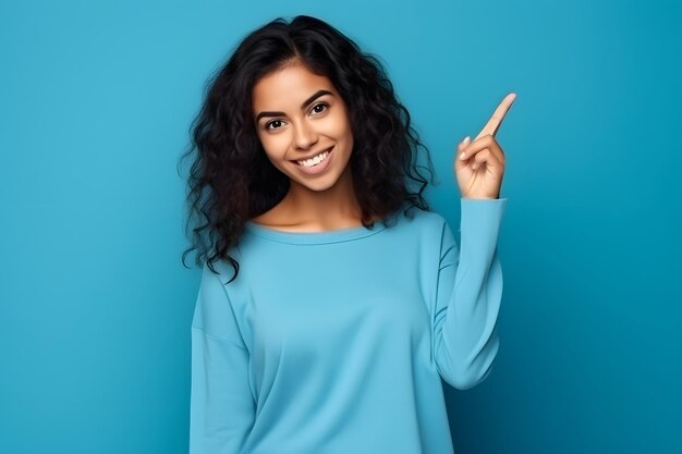 Young woman pointing finger to side latin girl isolated on blue