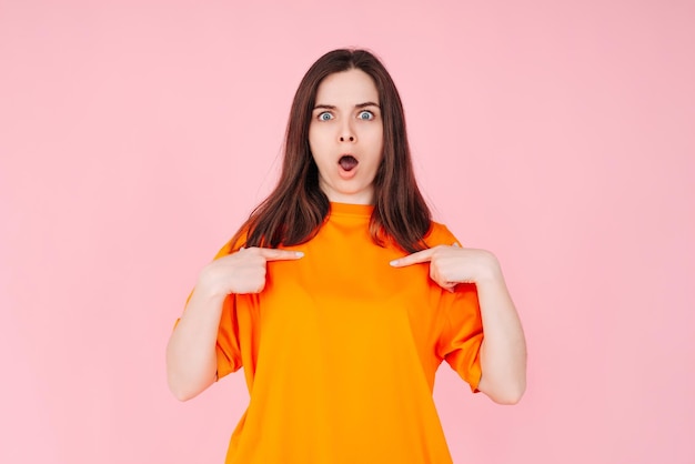 Young Woman Pointing at Herself in Amazement Expressing Belief in Winning the Competition Positive