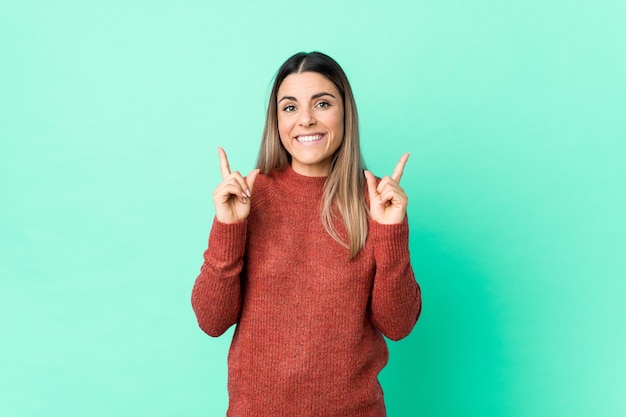 Young woman pointing up and smiling