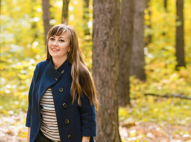 Young woman portrait in autumn park