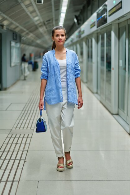 Young woman portrait inside metro subway.