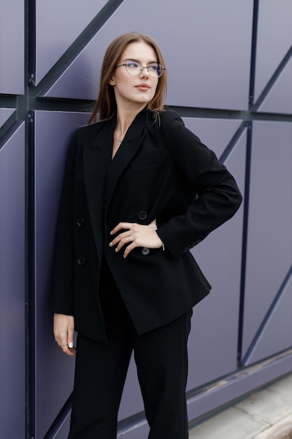 young woman portrait outdoor in black wear