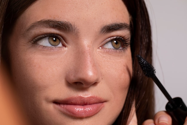 Foto ritratto di giovane donna con un prodotto per il trucco