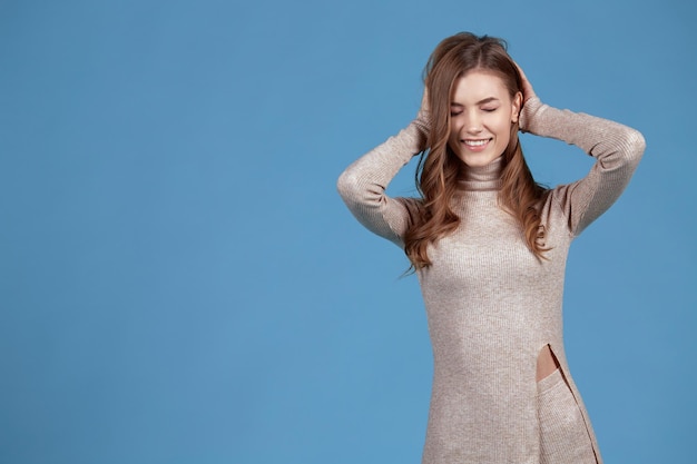 A young woman poses with a happy face