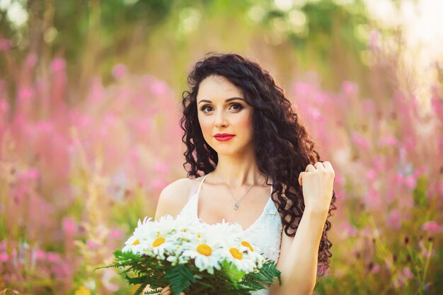 A young woman posing on a field