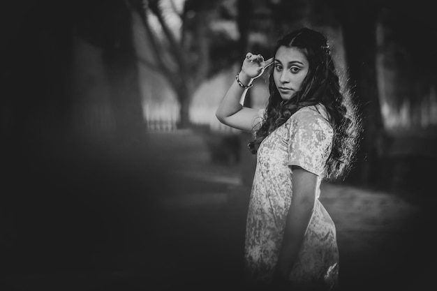 Young Woman Posing In A Garden In Black And White