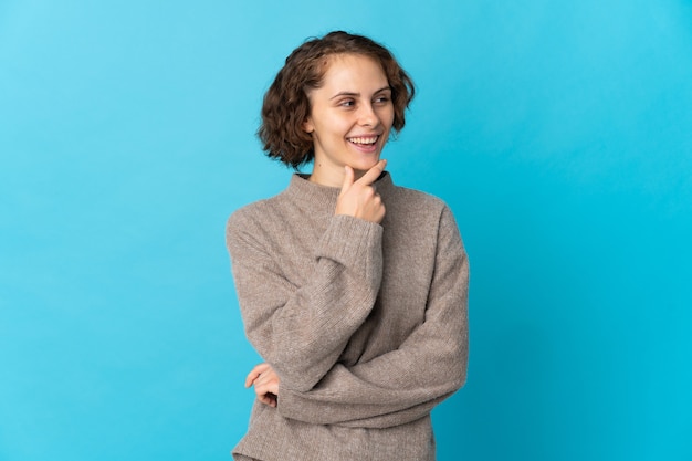 Young woman posing isolated against the blank wall