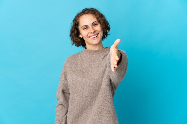 Young woman posing isolated against the blank wall