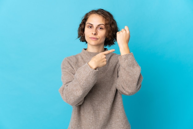 Young woman posing isolated against the blank wall