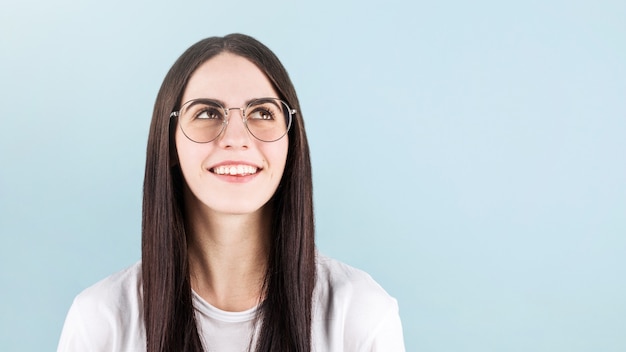 Young woman posing isolated over blue wall background