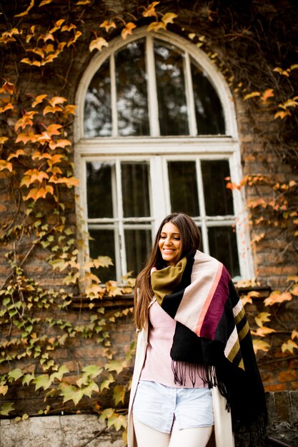 Young woman posing outside in autumn day