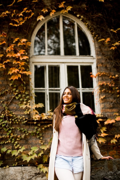 Young woman posing outside in autumn day