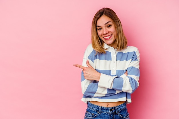 The young woman posing on pink background