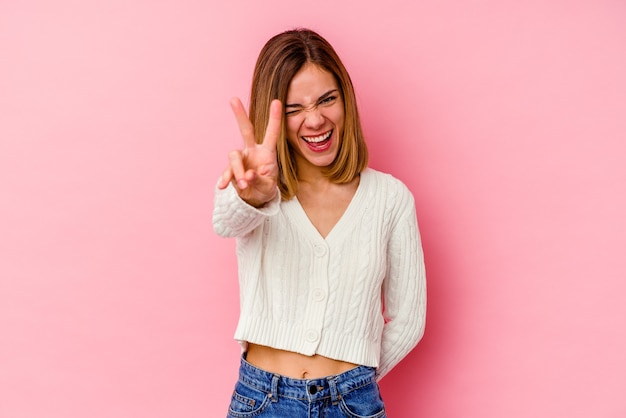 The young woman posing on pink background