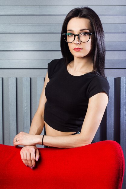 Young woman posing in red chair