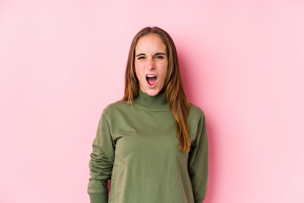 Young woman posing  screaming very angry and aggressive