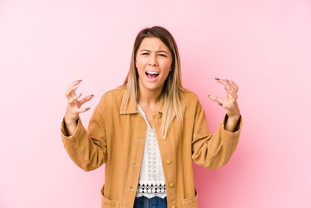 Young woman posing screaming with rage.