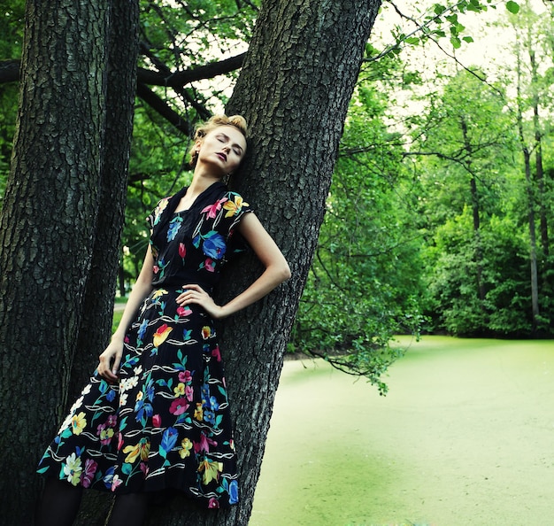 Young woman posing on a tree