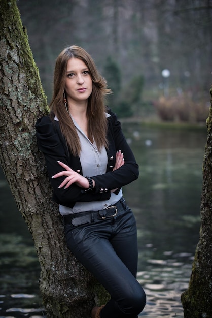 young woman posing at the tree