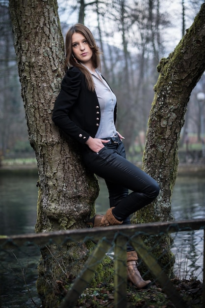 young woman posing at the tree