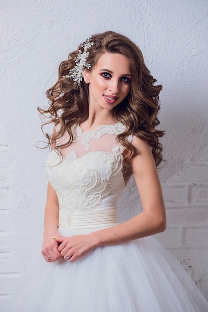 Young woman posing with beautiful wedding dress