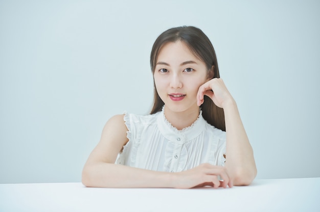 Young woman posing with elbows and white background