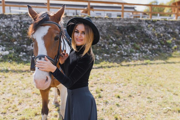 Young woman posing with a horse