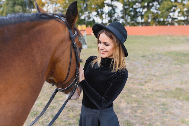 Young woman posing with a horse