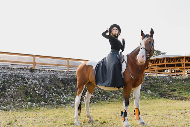 Young woman posing with a horse