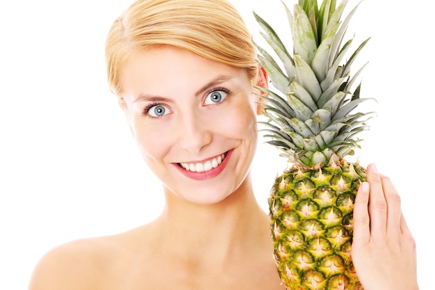 a young woman posing with pineapple over white background