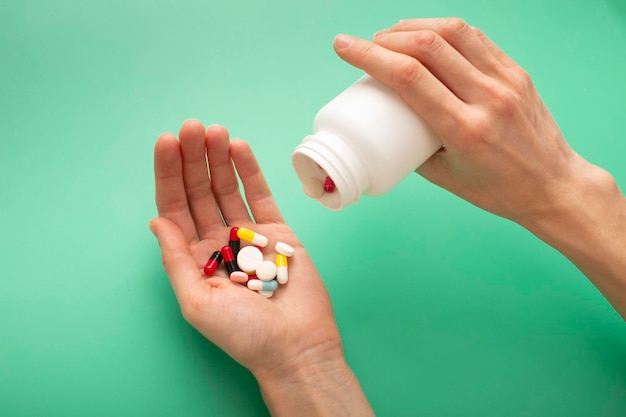 The young woman pours the pills out of the bottle