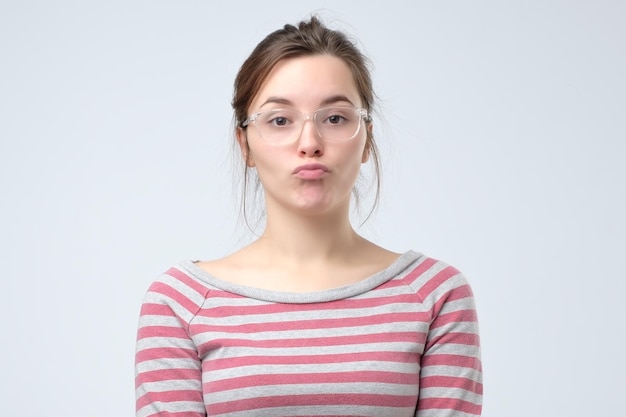 Young woman pouting lips making duck face