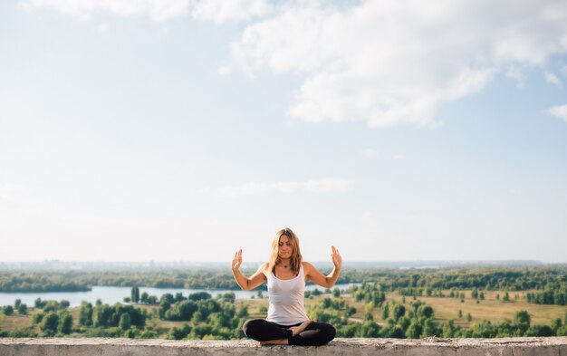 Young woman practices yoga outside