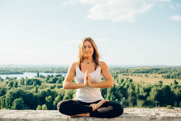 Young woman practices yoga outside