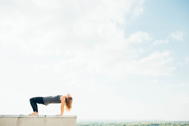 Young woman practices yoga outside