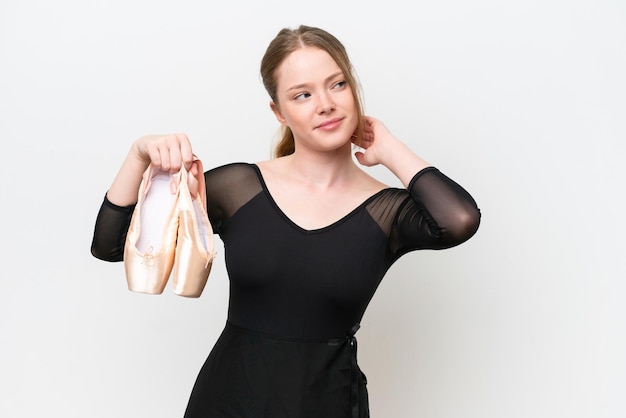 Young woman practicing ballet isolated on white background having doubts