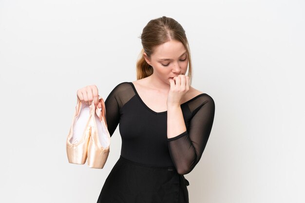 Young woman practicing ballet isolated on white background having doubts